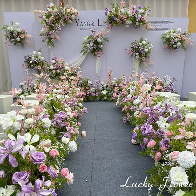 Outdoor Wedding Decoration with vibrant artificial flowers creating a romantic ceremony pathway.